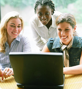 3 people looking at a laptop